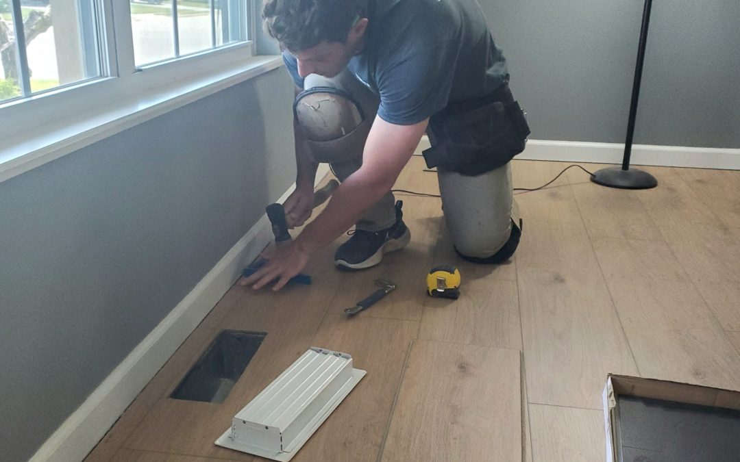 Yoder Flooring installer working on a hardwood installation in a home