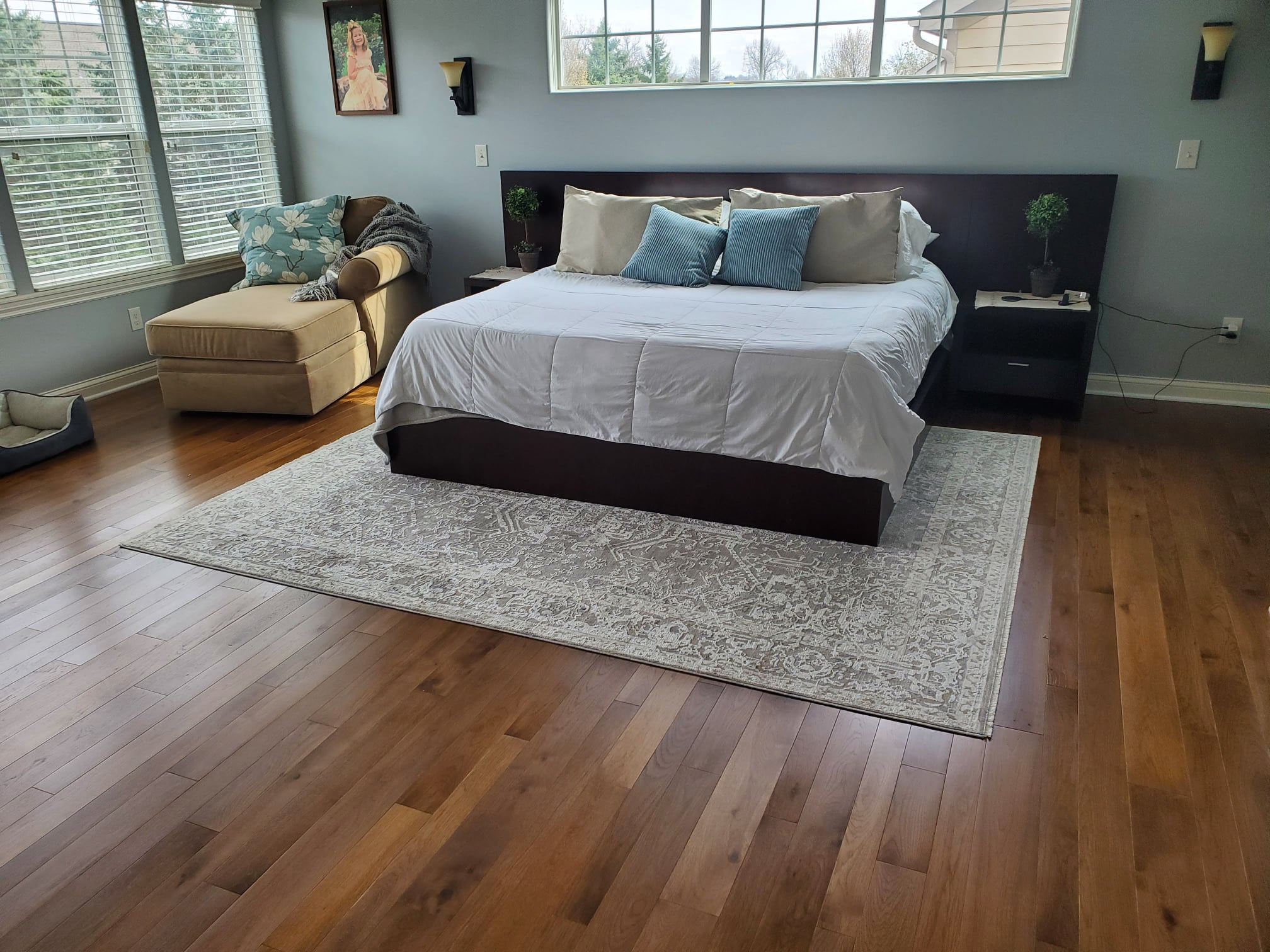 Well-lit master bedroom with solid hickory hardwood floors from Yoder Floors.